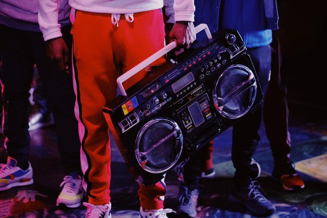 A hip-hop dude from the 80s holding a ghetto blaster radio